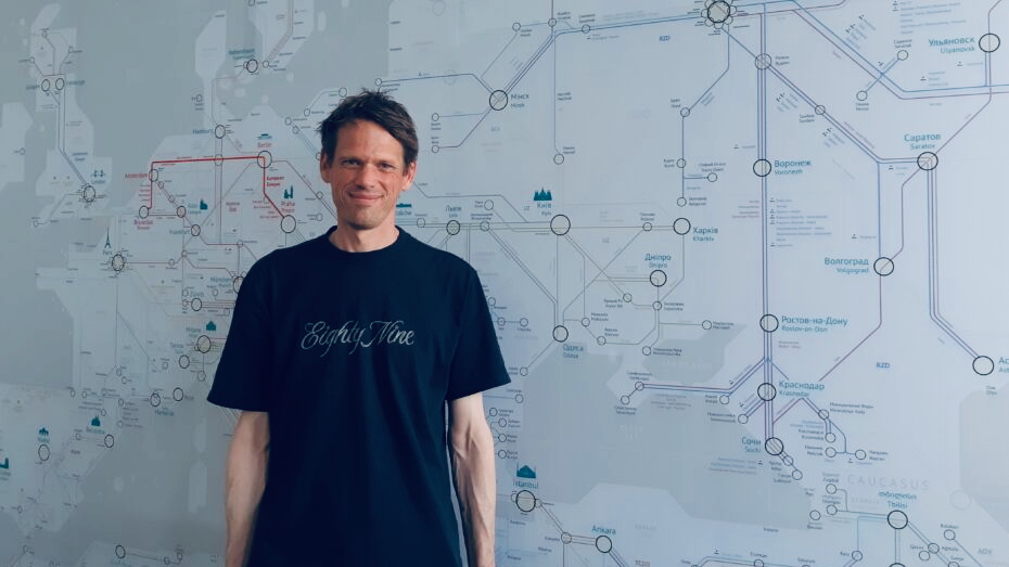 Chris Engelsman in front of a night train map.